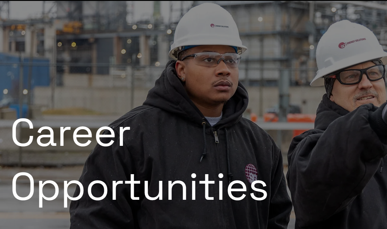 Two construction workers in hard hats and safety glasses at an industrial site with Career Opportunities text