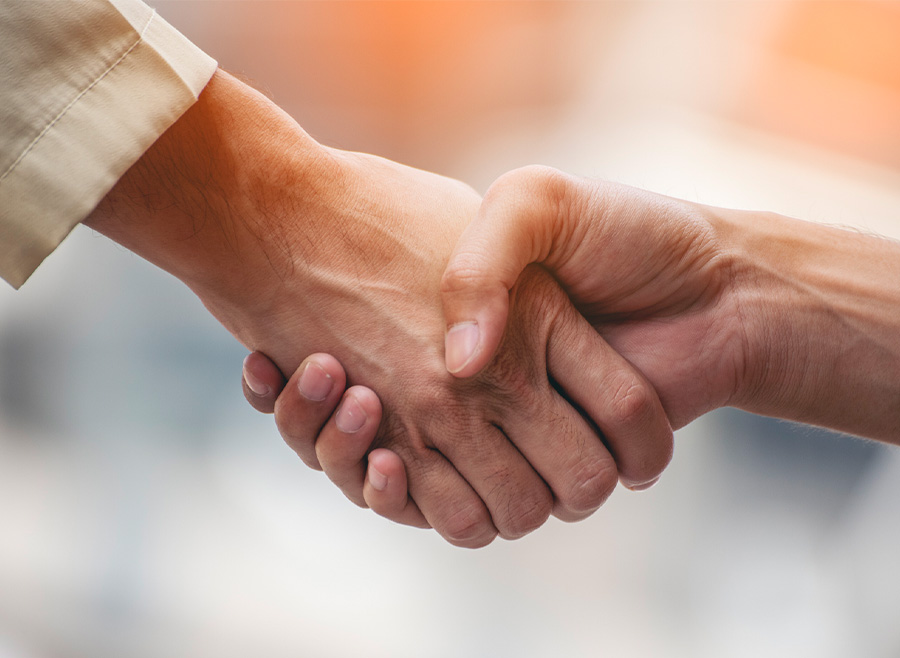 Close-up of two people shaking hands, symbolizing business agreement and partnership